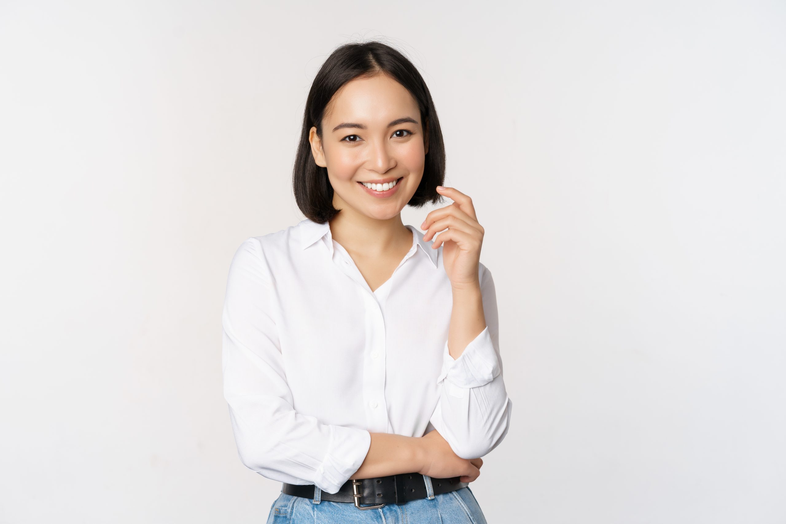 Young asian woman, professional entrepreneur standing in office clothing, smiling and looking confident, white background