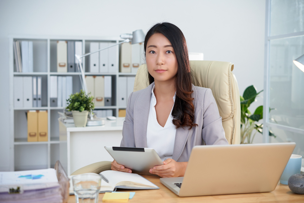 Singapore company secretary reviewing corporate compliance on a laptop with business clients