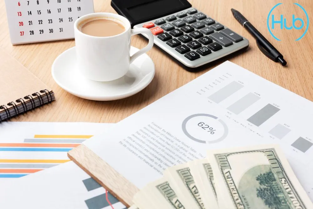 Financial planning documents, a calculator, and a desk calendar symbolizing the selection of a company's financial year end (FYE) in Singapore.